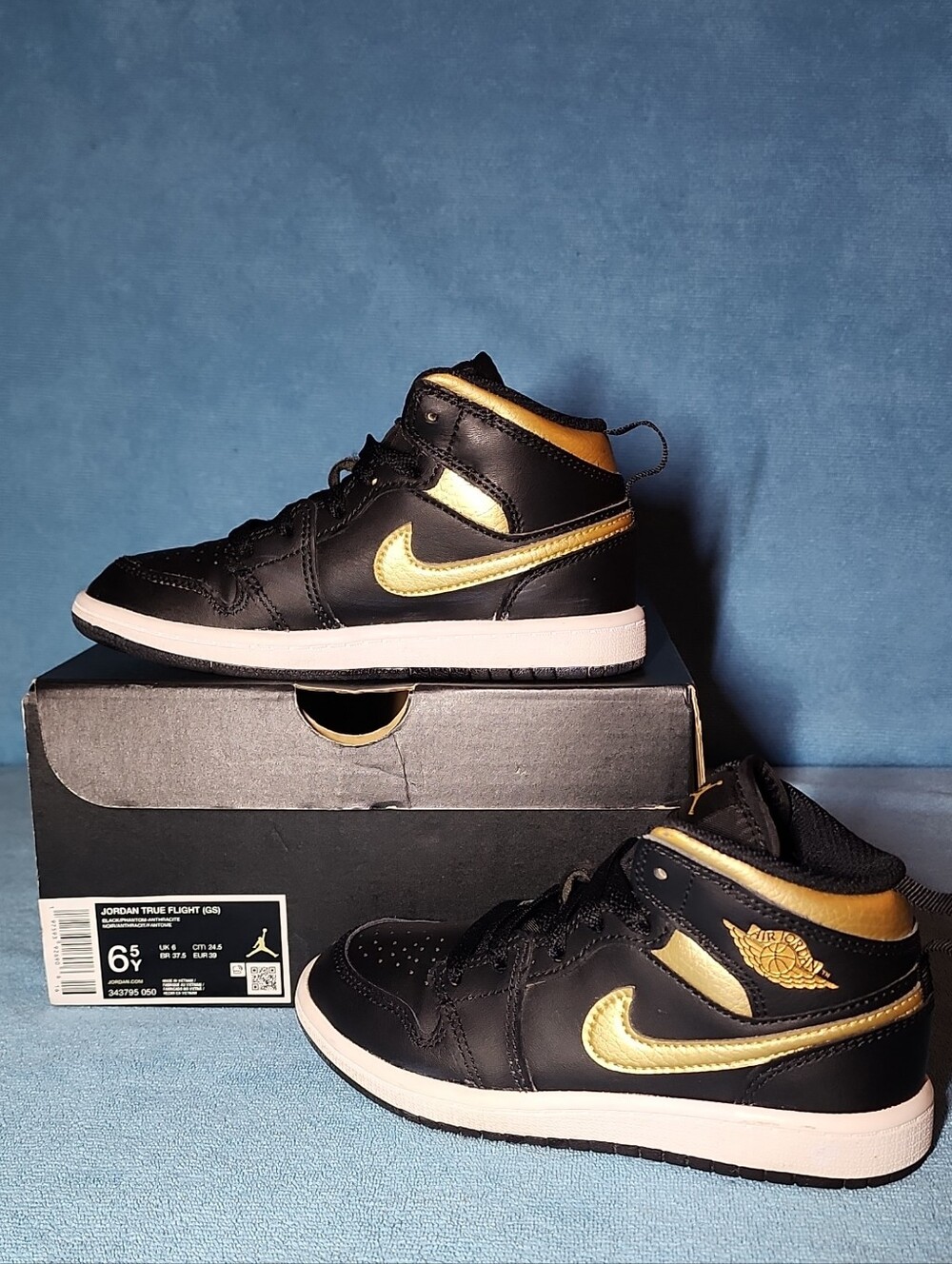 Jordan Black and Metallic Gold Mid-Top Sneakers